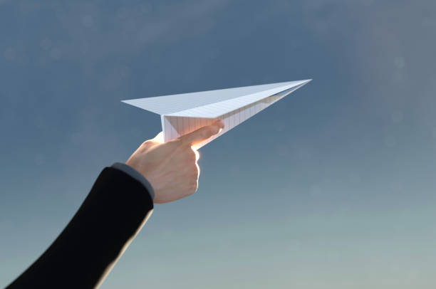 istock 3D Illustration. 3D Rendering , Concept of business success  to the target , startup , creative idea . Business man hand on paper plane white flying on sky between cloud. 1417612054
