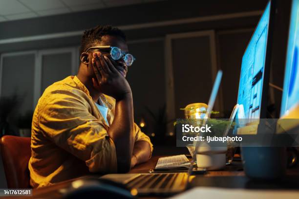 Bored Male Programmer Working On Pc In The Office Stock Photo - Download Image Now - Computer Programmer, Boredom, Night