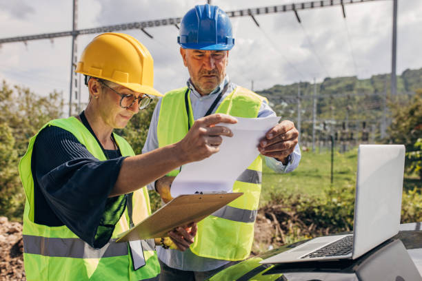 istock Male and female Electrical engineers working on power plant 1417612592