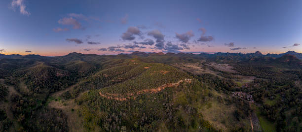 Warrumbungle National Park Aerial panorama view of the Warrumbungle National Park, NSW, Australia, at Sunset. With Camp Blackman campground visible at the bottom right. warrumbungle national park stock pictures, royalty-free photos & images