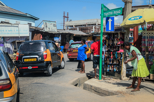 Cape Coast, Ghana - April 14, 2022: Crowded Cape Coast Street with Ghana People and Cars near the local Market