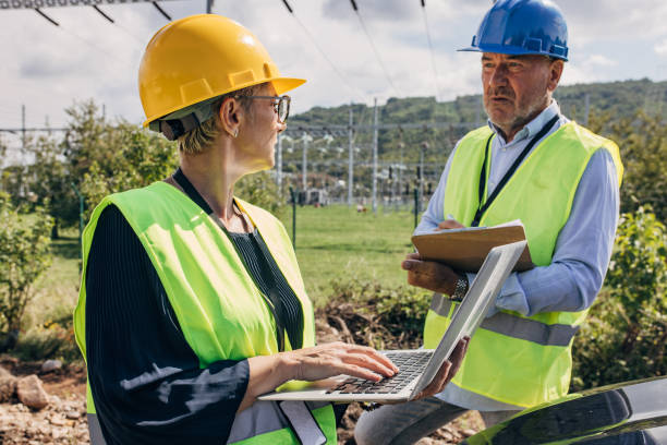 istock Electrical Engineers Using Laptop and checkup board In Power Station 1417614874