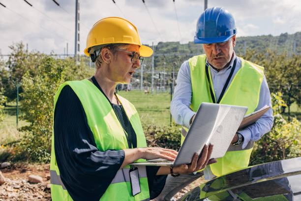 istock Electrical Engineers Using Laptop and checkup board In Power Station 1417615649