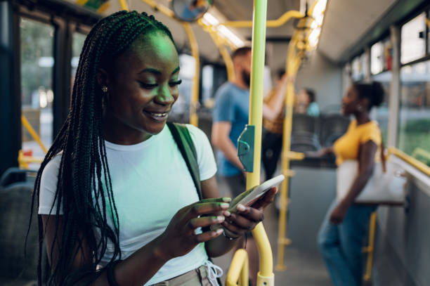 istock African american woman using smartphone while riding a bus in the night 1417616803