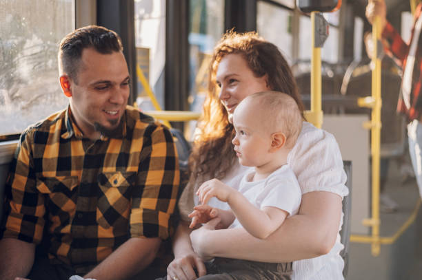 istock Parents riding a bus with their child during a day. 1417616819