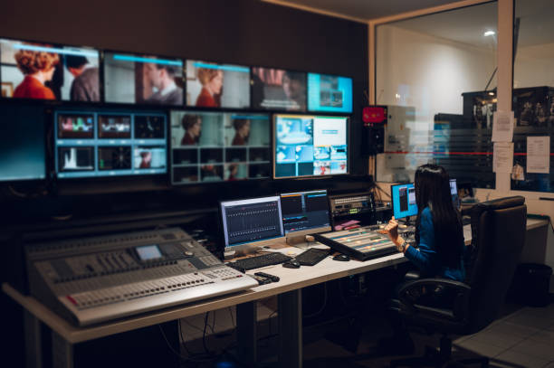 Middle aged woman using equipment in control room on a tv station Middle aged beautiful woman working in a broadcast control room on a tv station. Entertainment news with footage equipment concept. Focus on a equipment on the table. photo editing screen stock pictures, royalty-free photos & images