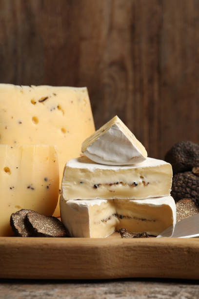 istock Different types of cheese and truffles on wooden board 1417617535