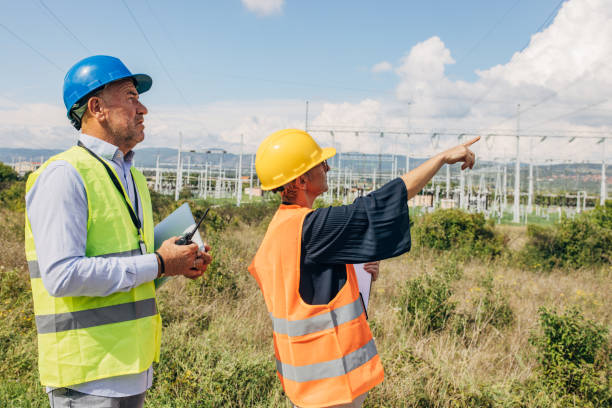 istock Electrical Engineers Using checkup board and talk on walkie-talkie In Power Station 1417618037