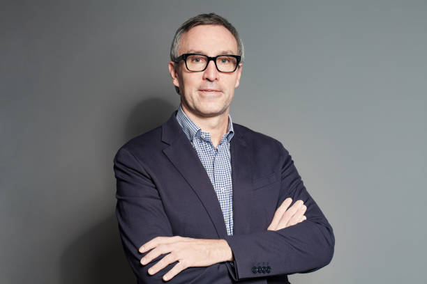 istock Smart friendly professional man wearing glasses on grey background 1417619856