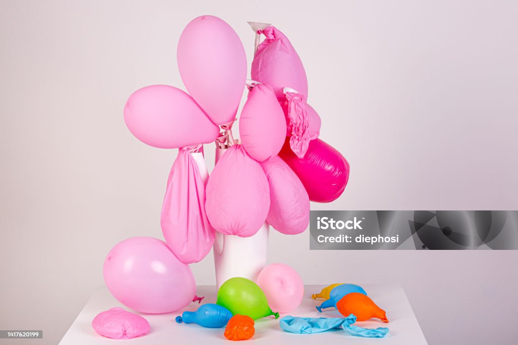 Powerless limp balloons, symbolic of failure and powerlessness Balloon Stock Photo