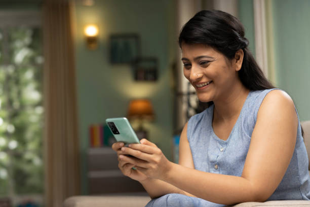 istock Woman using phone at home, stock photo 1417622830