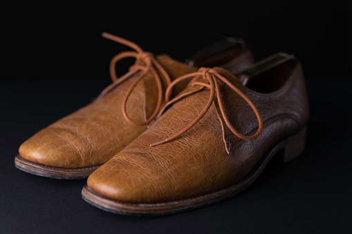 Old leather shoes on white background