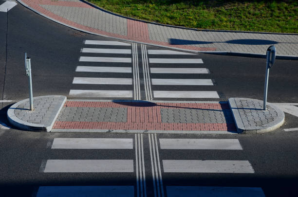 directionally divided lanes at intersection. crossing has a raised safety island for pedestrians. signage for blind. comprehensive traffic marking of street intersections. expertise transport studies,