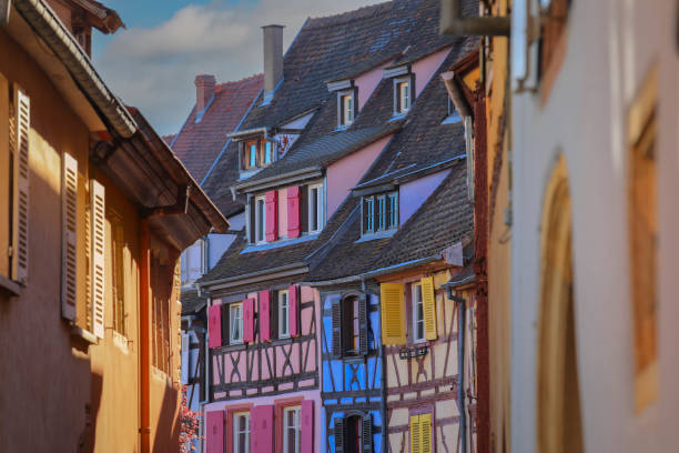 Colourful traditional half-timbered houses in Colmar Selective focus on Traditional half-timbered houses on street in Colmar at twilight , Alsace rigion, France colmar stock pictures, royalty-free photos & images