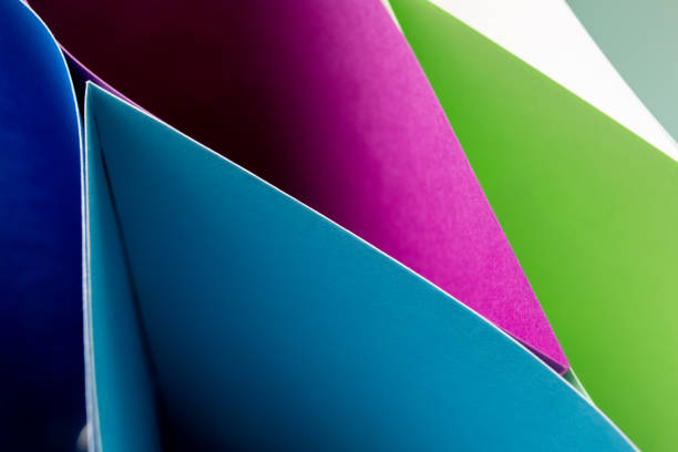 Smooth curved shapes in vibrant green and red create a dynamic interplay of color and form, suggesting a sense of movement and modern design