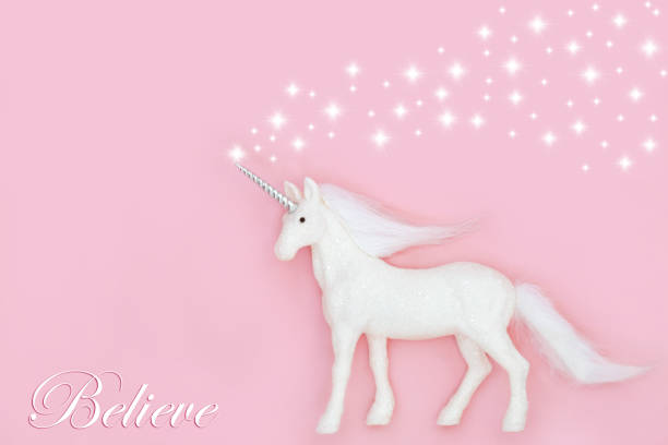 Christmas mythical magical unicorn with believe in magic theme on pink background with white stars. Fairy tale abstract for Xmas and New Year holiday season.