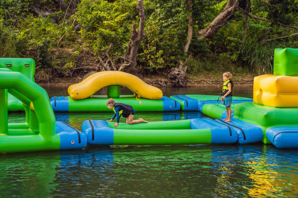 istock Two boy runs an inflatable obstacle course In the lake 1417629065