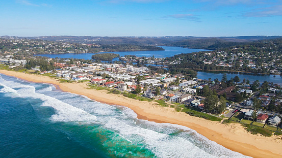 Aerial drone view of Collaroy Narrabeen Beach on the Northern Beaches of Sydney, NSW, Australia with views of South Creek and Narrabeen Lagoon in the background on a sunny day