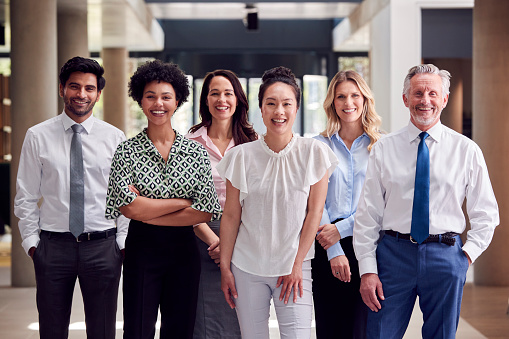 Cropped portrait of a diverse group of businesspeople standing with their arms crossed in their office
