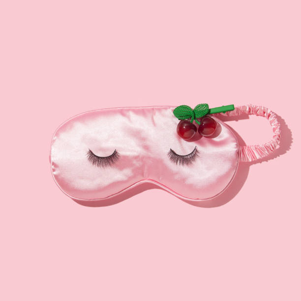 istock Summer or Spring romantic creative layout with pink sleep mask with cherry hair clip and false eyelashes on pastel pink background. 80s or 90s retro fashion aesthetic concept. Minimal surreal cosmetic beauty idea. 1417632372