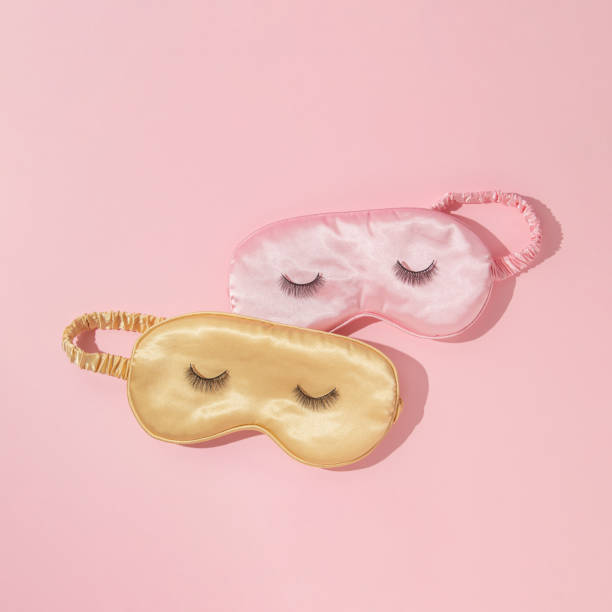 istock Romantic creative layout with pink and yellow sleep masks with false eyelashes on pastel pink background. 80s or 90s retro fashion aesthetic concept. Minimal surreal cosmetic beauty idea. 1417632382