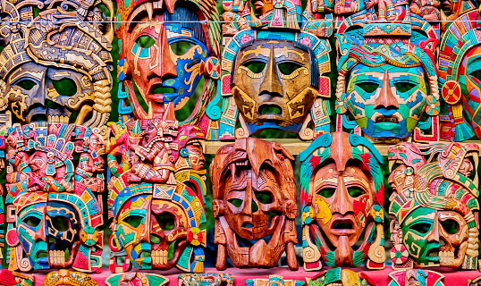 Wooden Maya & Aztec masks display at a street market stall, Tulum, Mexico