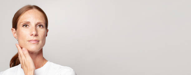 istock Mature woman face closeup on white banner background with copy space 1417635863