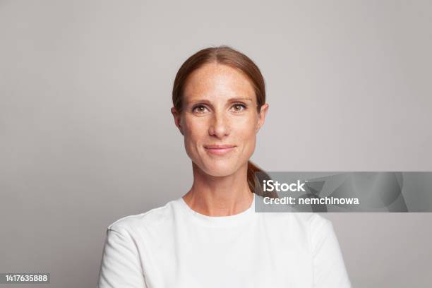 Cheerful Mid Adult Woman Face Mature Model Looking At Camera And Smiling Stock Photo - Download Image Now
