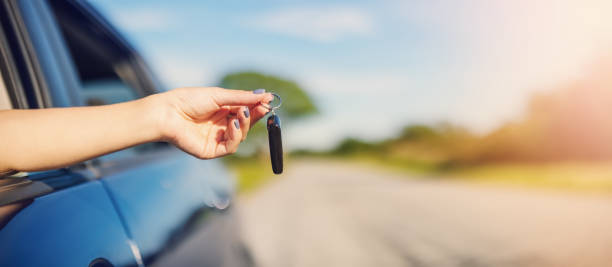 istock Woman's hand holding key from her new car 1417637703