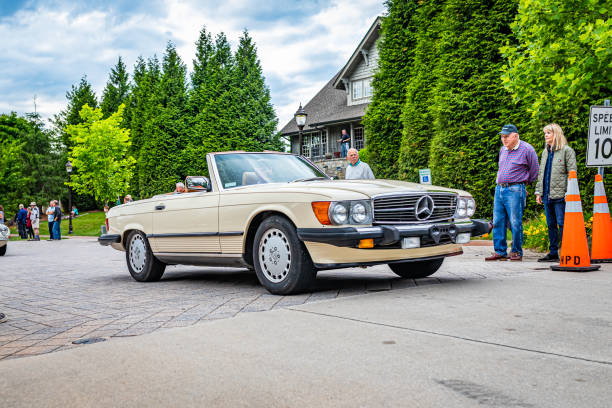 Highlands, NC - June 10, 2022: Low perspective front corner view of a 1987 Mercedes-Benz 560SL Convertible leaving a local car show.