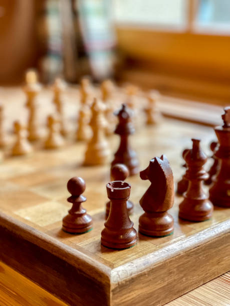 istock Old wooden chess board with focused tower 1417641450