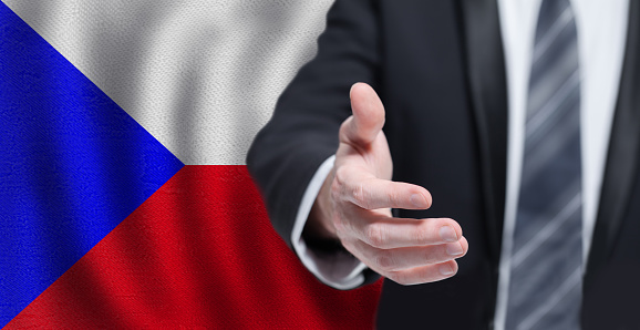 Welcome to the Czech Republic. Hand on Czech flag background. Business, politics, cooperation and travel concept