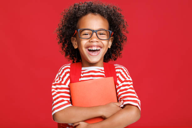 istock Happy ethnic schoolboy laughing with book 1417642586