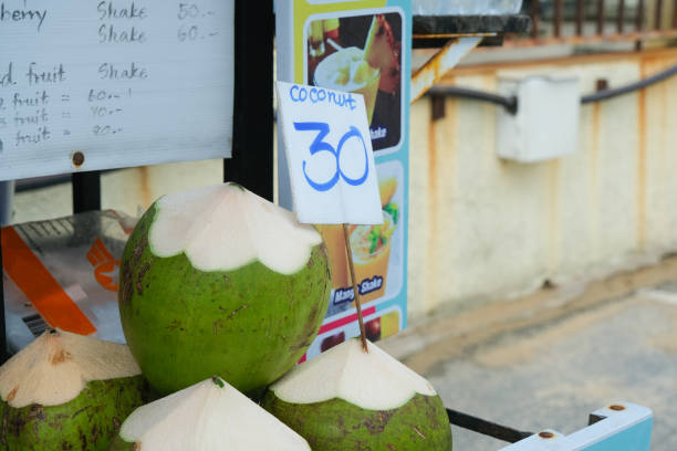 istock Coconuts are on street seller counter in a row 1417644901