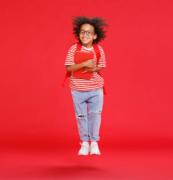 istock Energetic ethnic stylish schoolboy leaping up 1417646567