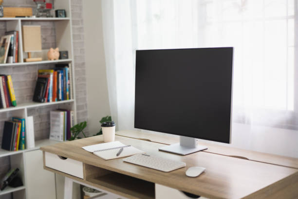 istock Close up view of worktable with laptop or computer, tablet, notebook and pen in home office room. Work at home place in the living room concept. 1417648195