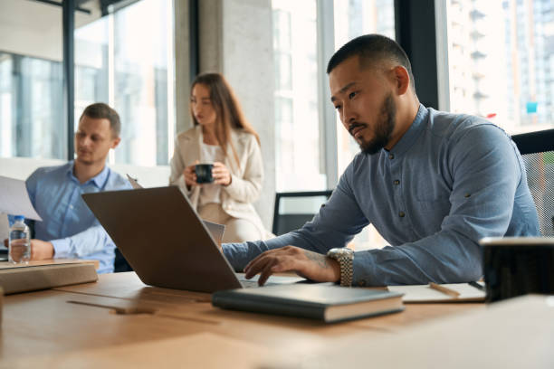 istock Close up portrait of handsome confident male working on notebook 1417648797