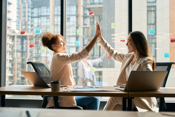 istock Female colleagues give high five to each other in office 1417648933