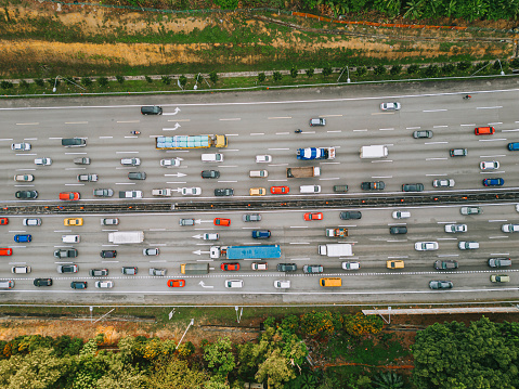 Highway and monorail route during the peak hour with traffic jam from drone aerial view