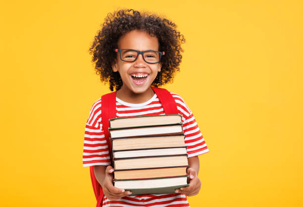 istock Excited ethnic schoolboy with  books laughing 1417650116