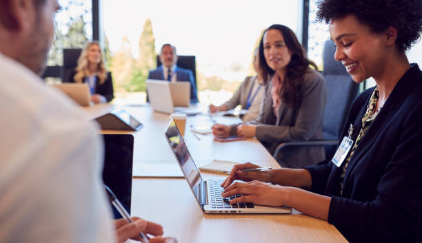 istock Multi-Cultural Business Team Meeting And Collaborating Around Table In Modern Office Building 1417650145