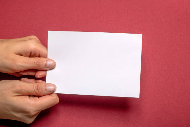 istock woman holding blank letter on red background 1417652389