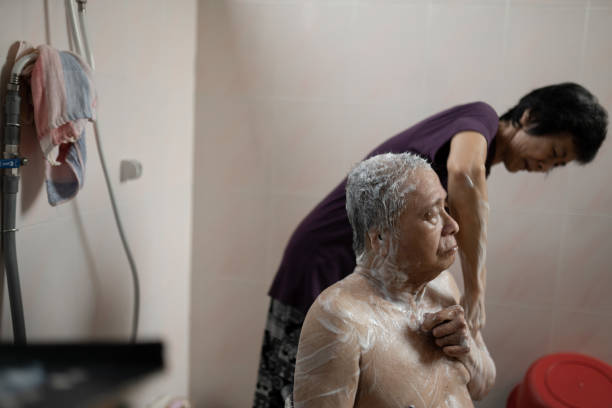 Asian Chinese healthcare worker helping patient taking bath