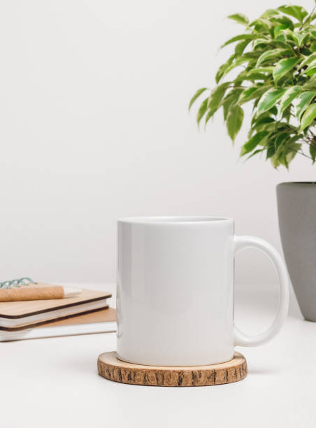 istock Mockup mug with notepads and houseplant at the background 1417659783