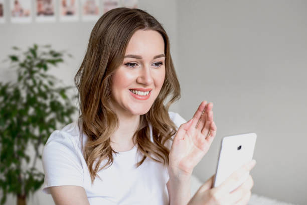 istock Happy woman browsing media or texting in a mobile smart phone 1417659833