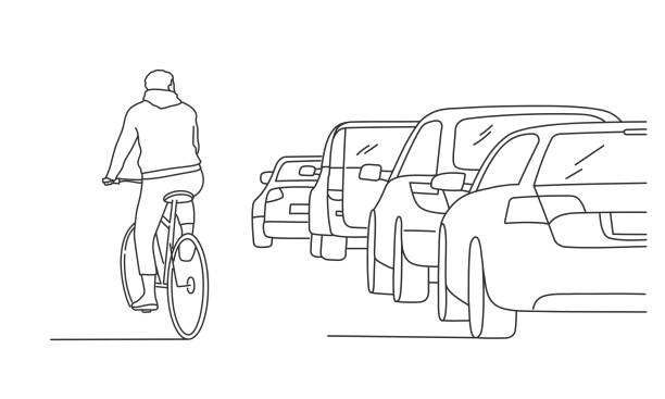 Cyclist in traffic. Cyclist in traffic. Hand drawn vector illustration. Black and white. car traffic jam traffic driving stock illustrations