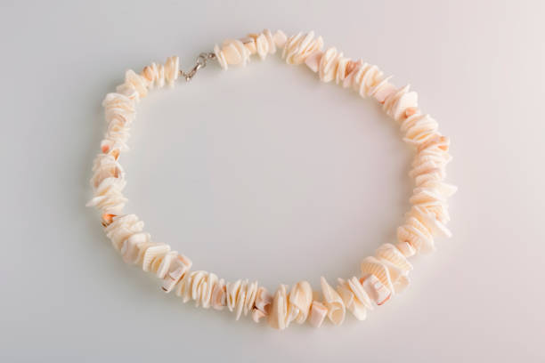 Close-up of a shell necklace with a defocused background. Handmade jewelry