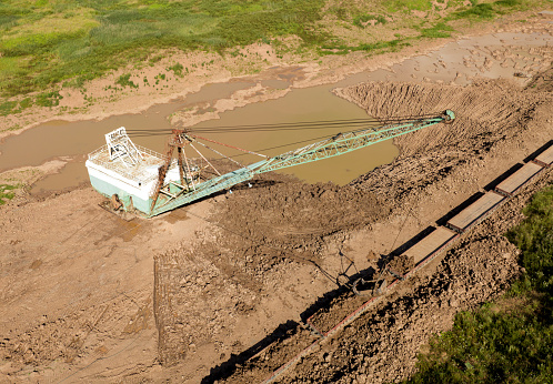 Dragline excavator works in an open pit for the extraction of clay. Largest Walking Dragline Excavator in the clay quarry. Big Muskie in open pit mining. Heavy mining equipment.