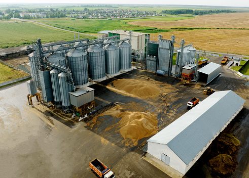 Grain storage. Silo at farm. Elevator for corn storage and grain. Feed Silos Hopper for wheat storage and barley. Storing grain and compound feeds. Agricultural warehouse. Wheat import in food crisis.