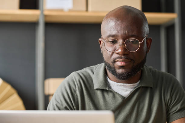 istock Man working on laptop in warehouse 1417664464